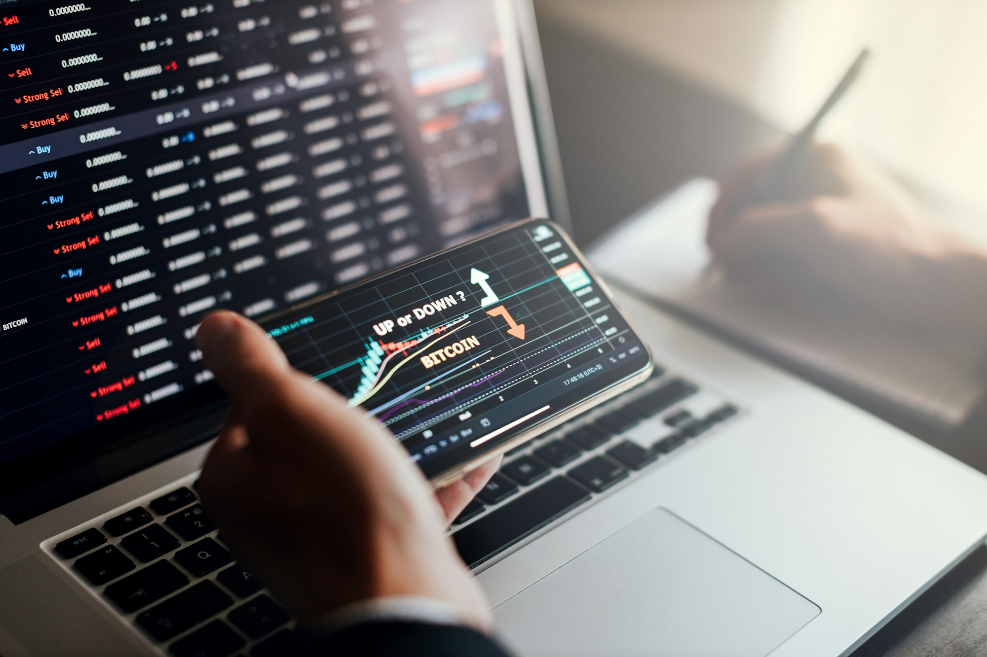 stockbroker using phone and laptop for profit gain analysis workplace